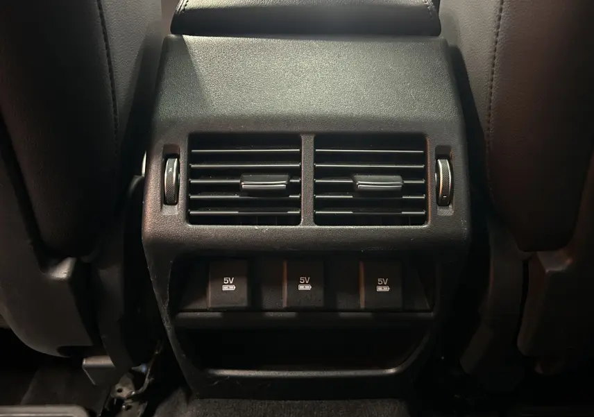 Détail de la console arrière avec bouches d’aération et ports USB 5V du Jaguar E-PACE beige 2018.