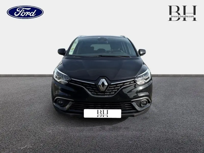 Vue de face du Renault Grand Scenic noir étoilé, mettant en valeur sa calandre distinctive et ses phares LED.