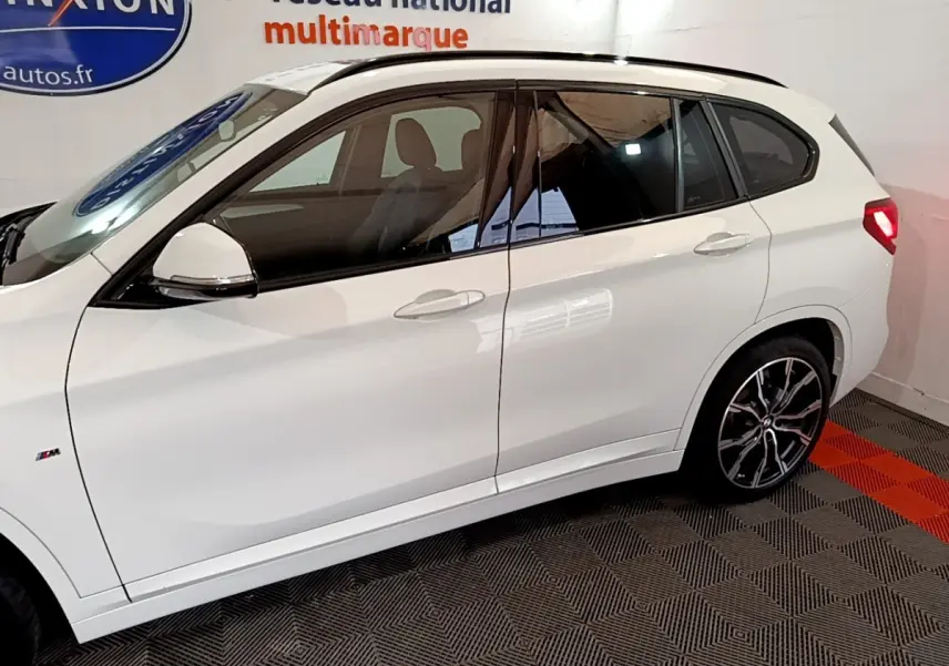 Profil droit d’un BMW X1 blanc sDrive18i M Sport 2022 avec jantes alliage et vitres teintées.