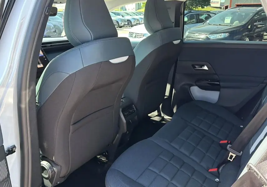 Vue intérieure arrière côté gauche du Citroën C5 Aircross blanc, montrant les sièges arrière et dossiers avant noirs.