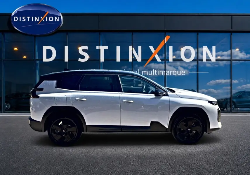 Profil droit du Citroën C5 Aircross 2026 blanc avec toit noir et jantes alliage noires devant une vitrine Distinxion.