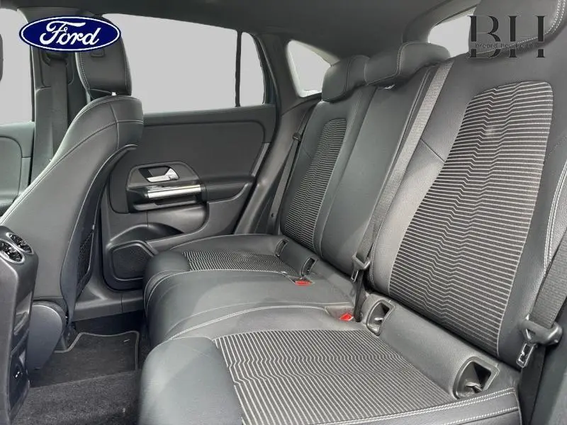 Vue intérieure côté droit des sièges arrière en tissu noir avec motifs rayés sur un Mercedes GLA 250 e bleu denim métallisé 2020