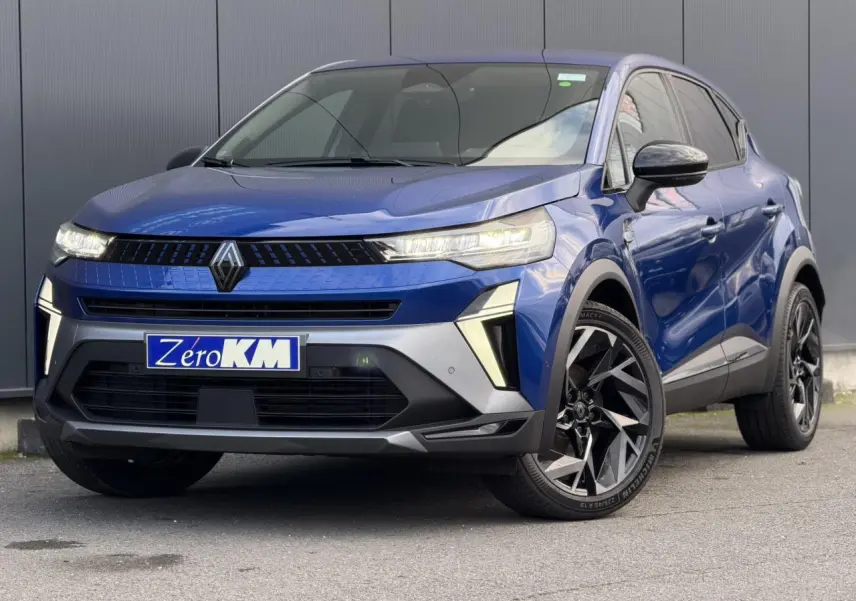 Renault Captur E-Tech hybride bleu Iron en 3/4 avant droit avec jantes noires et badge Alpine visible.