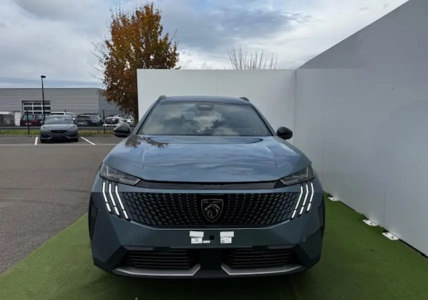 Vue frontale du Peugeot 5008 bleu Ingaro métallisé avec calandre noire et feux LED à griffes distinctifs.