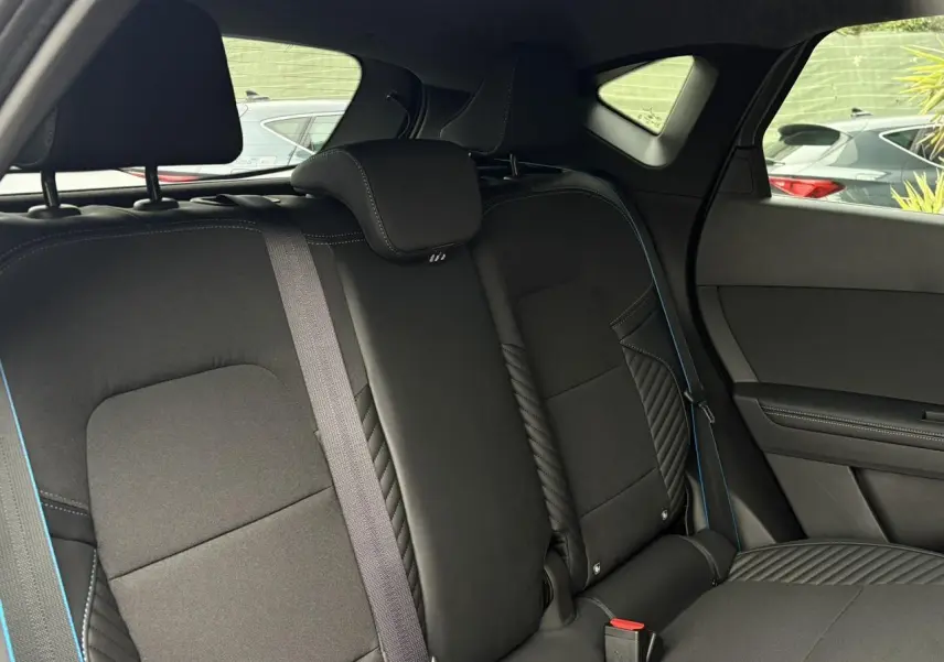 Vue intérieure côté droit des sièges arrière noirs avec surpiqûres bleues du Renault Captur Esprit Alpine 2025.