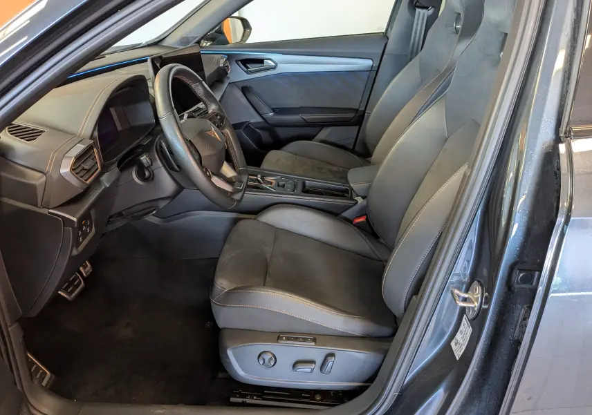 Vue intérieure côté conducteur de la CUPRA Formentor gris magnétique, sièges cuir et alcantara avec surpiqûres contrastées.