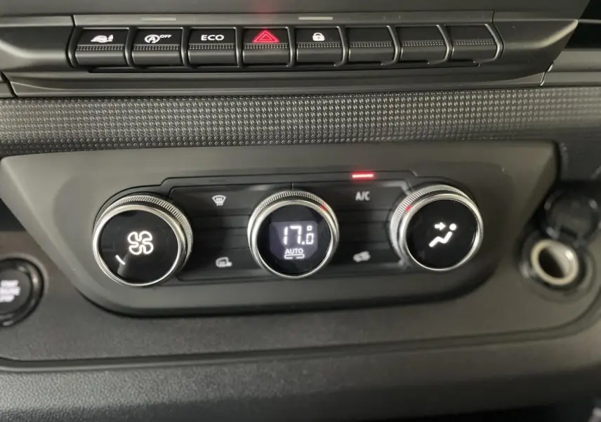 Gros plan sur les commandes de climatisation automatique du Renault Trafic Fourgon, affichant 17°C.