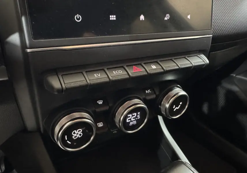 Gros plan sur la console centrale noire du Renault Arkana Business E-TECH 145 avec commandes climatisation et boutons fonctionnels.