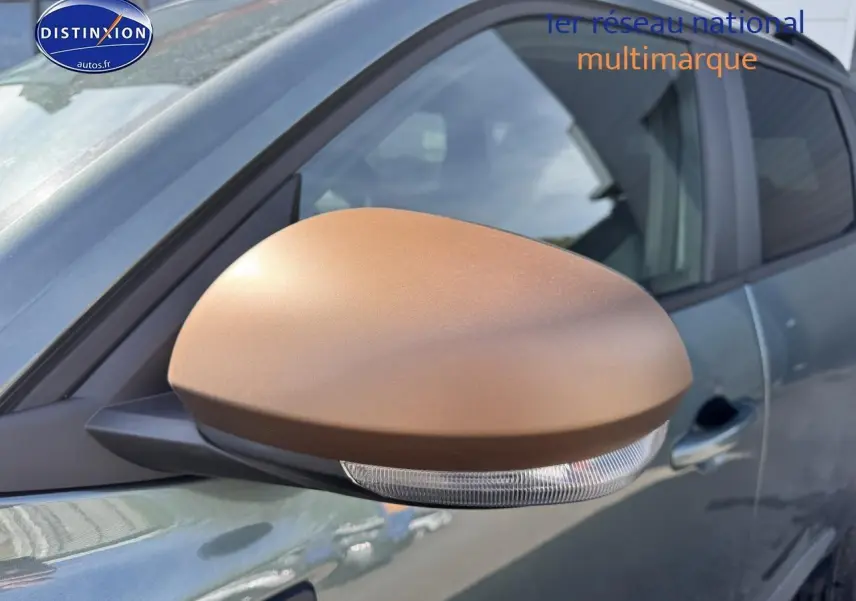Rétroviseur droit marron mat sur Dacia Duster vert cèdre 2025, vue rapprochée côté conducteur.