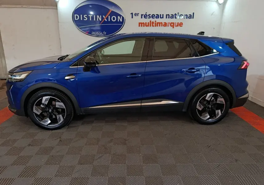 Renault SYMBIOZ bleu en profil droit dans un showroom, soulignant ses jantes noires et détails chromés.