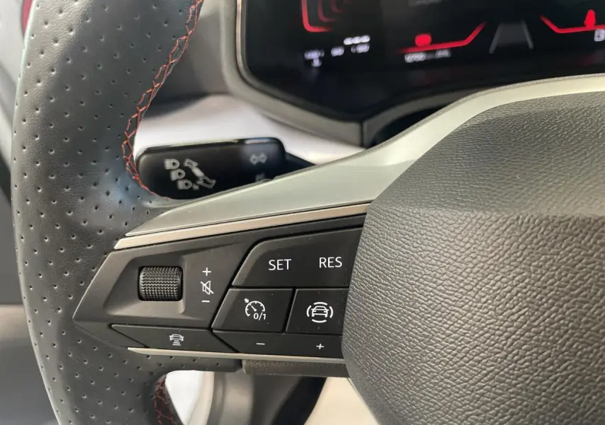 Gros plan sur le volant cuir perforé avec commandes multifonctions du SEAT Arona 2024, finition FR, intérieur noir.