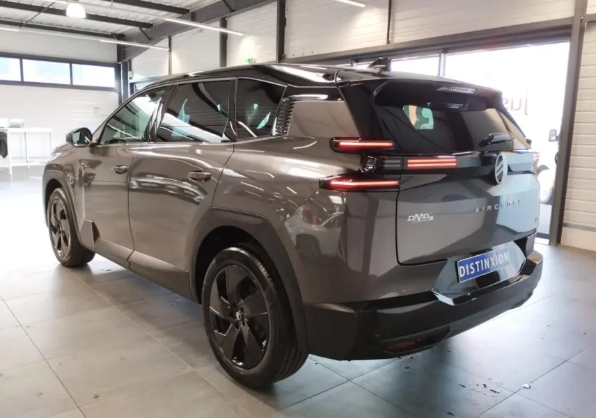 Vue 3/4 arrière droit d'un Citroën C5 Aircross gris platine avec feux arrière LED et jantes alliage noires.