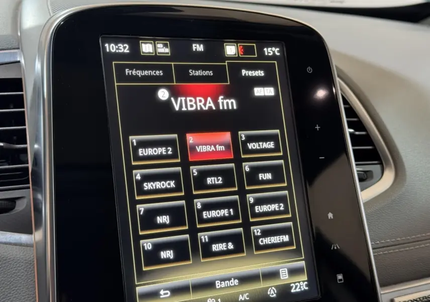 Gros plan sur l'écran tactile central du Renault Espace gris foncé, affichant les stations radio FM.