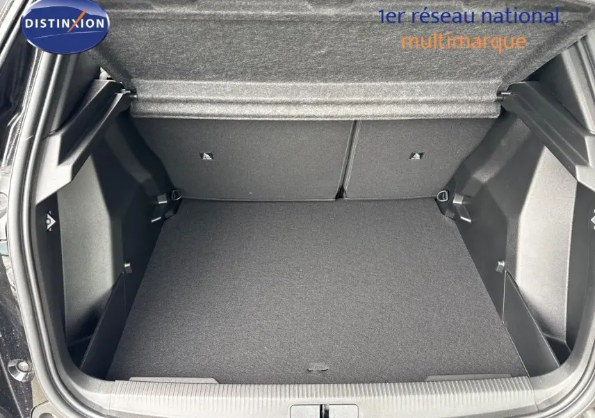 Coffre ouvert d'un Peugeot 2008 noir métal, vue de l'arrière montrant un espace de chargement propre et spacieux.