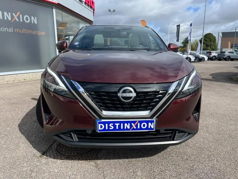 Vue frontale d'un Nissan Qashqai e-POWER 2023 en Rouge Passion avec calandre noire et logo Nissan visible.