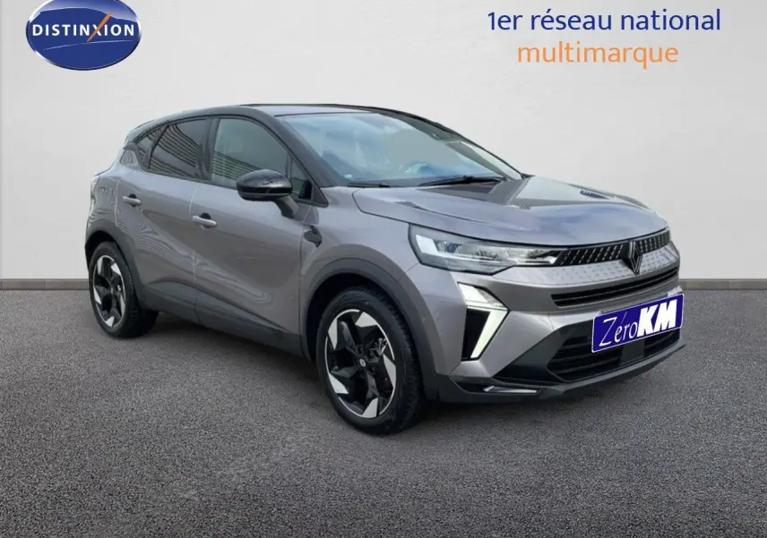Renault Captur E-Tech hybride gris cassiopée métal avec toit noir, vue 3/4 avant mettant en valeur ses jantes stylisées.