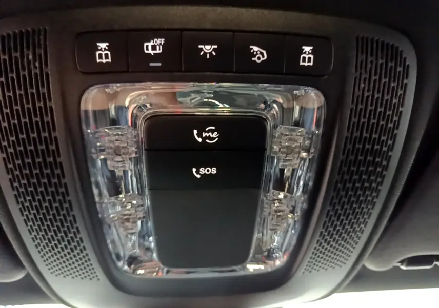 Vue en gros plan du plafonnier noir avec boutons d’appel d’urgence et éclairage intérieur d’une Mercedes CLA 200 d blanche.