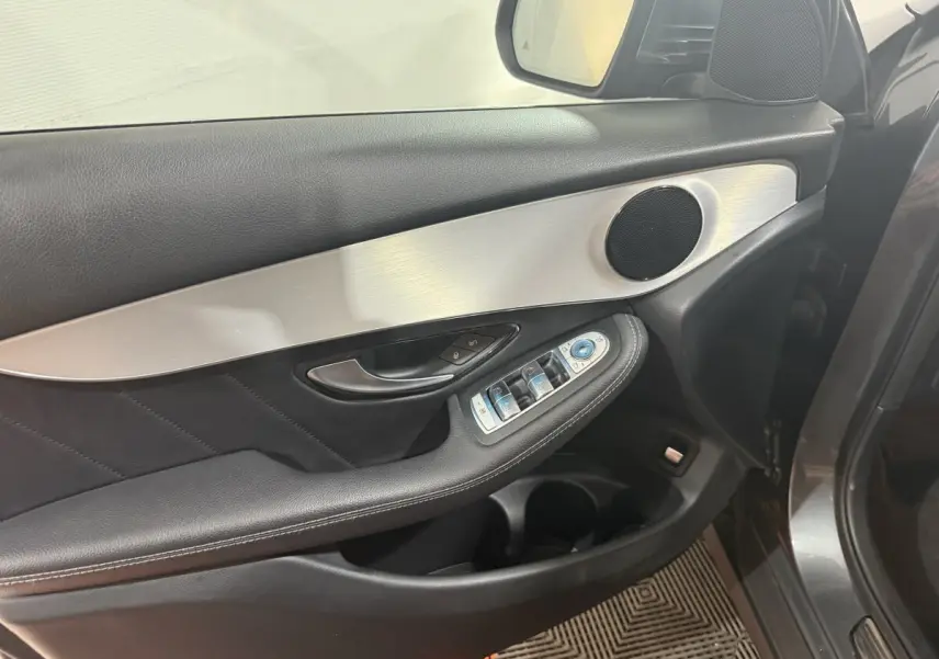 Détail de la porte côté conducteur du Mercedes GLC 250 Fascination 2019, avec garniture noire et insert aluminium brossé.