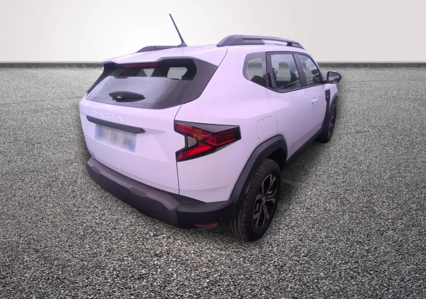 Vue 3/4 arrière droite d'un Dacia Duster blanc avec barres de toit noires et feux arrière LED distinctifs.
