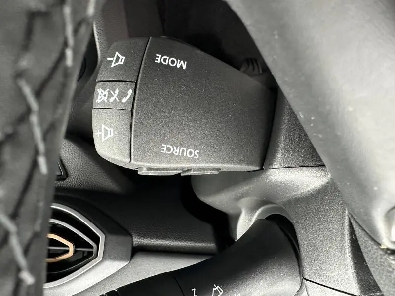 Gros plan sur la commande audio au volant du Dacia Jogger 2024, finition brun Terracota métallisé.