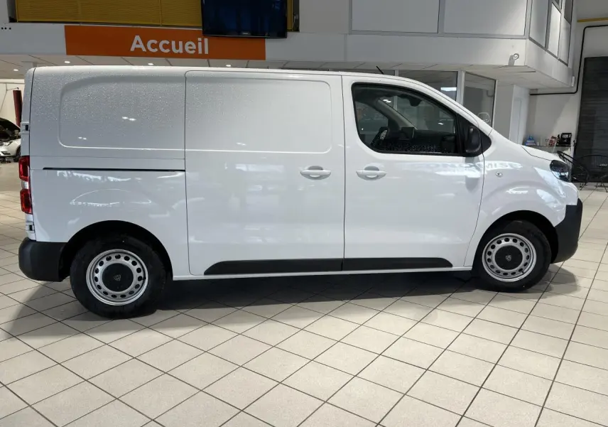 Vue latérale droite d'un Peugeot Expert Fourgon blanc 2024 en showroom, avec jantes acier et poignées de porte assorties.