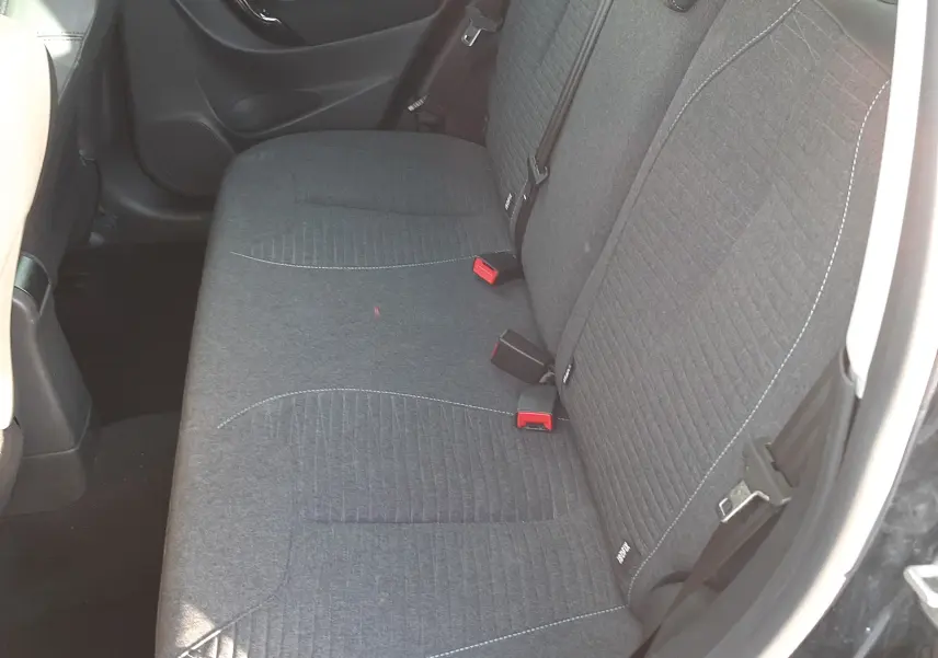 Vue intérieure côté droit montrant la banquette arrière en tissu gris de la Citroën C3 noire de 2016.