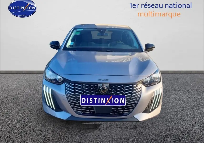 Vue avant d'une Peugeot 208 1.2 100 Allure gris Artense avec feux diurnes LED en forme de griffes visibles.