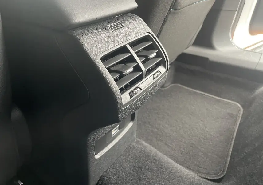 Bouche d'aération arrière noire et port USB dans l'habitacle arrière d'une Citroën C4 blanche 2022.