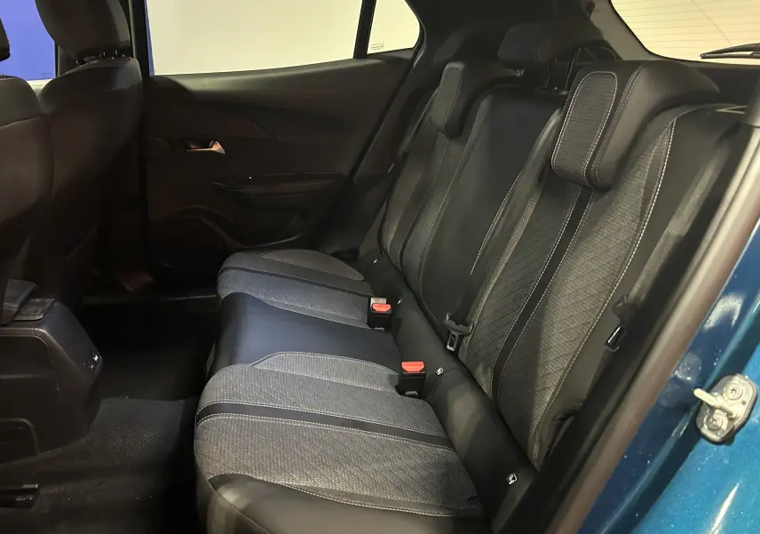 Vue intérieure côté droit des sièges arrière en tissu et cuir noir du Peugeot 2008 Allure Hybrid 145 Bleu Obsession 2025.