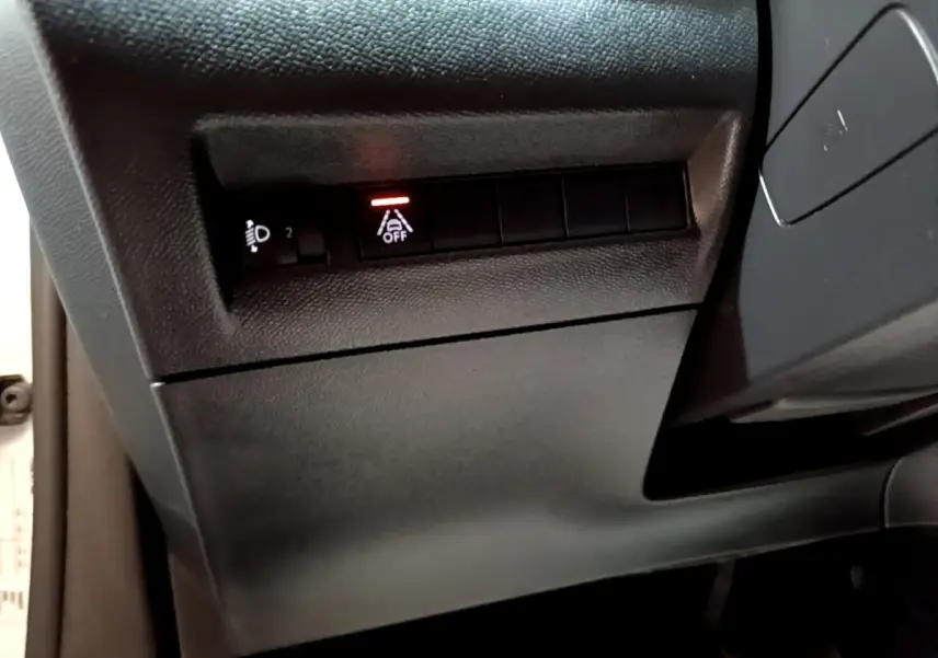 Vue rapprochée du tableau de bord côté gauche du Peugeot 2008 blanc, avec bouton d'assistance au maintien de voie désactivé.