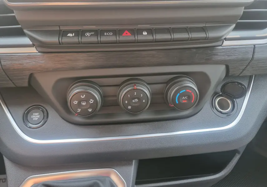 Gros plan sur la console centrale du Renault Trafic Combi 2026, montrant les commandes de climatisation et boutons fonctionnels.