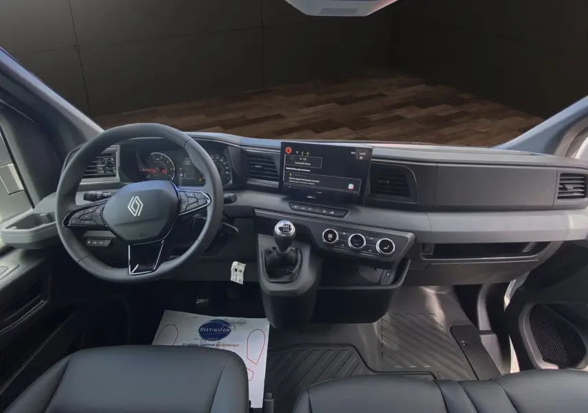 Intérieur du Renault Master 2025 vu de face, tableau de bord moderne avec écran tactile et volant multifonction noir.