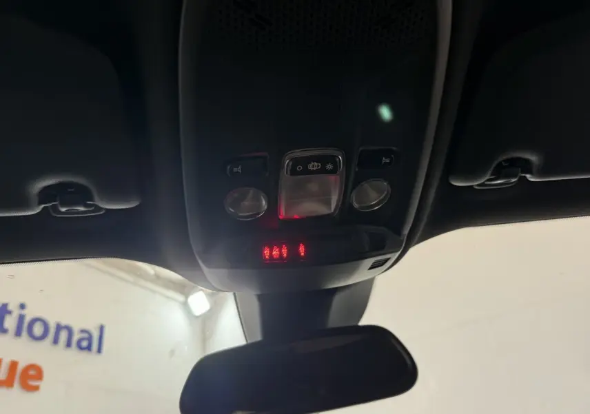 Vue intérieure du plafonnier et rétroviseur central d'une Peugeot 2008 gris clair, avec commandes et voyants lumineux rouges.