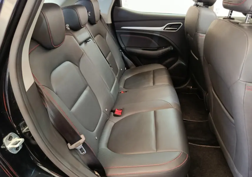 Vue intérieure côté gauche des sièges arrière en cuir noir avec surpiqûres rouges du MG MOTOR ZS Luxury 2024.
