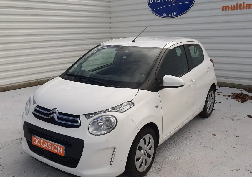 Citroën C1 blanche vue 3/4 avant droit, compacte cinq portes avec phares ronds et calandre noire.
