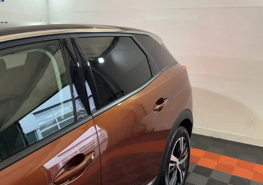 Vue latérale gauche rapprochée du Peugeot 3008 orange 2020, mettant en valeur la porte arrière et la jante alliage.