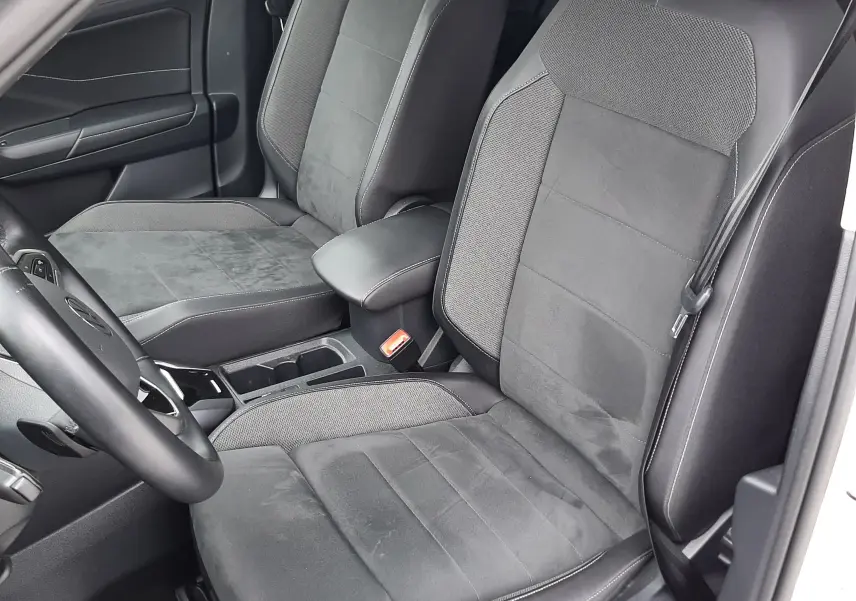 Vue intérieure côté gauche montrant les sièges avant en tissu noir et alcantara du Volkswagen T-Roc 2022.