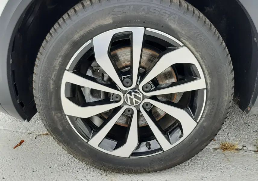 Gros plan sur la jante alliage bicolore noir et argent du Volkswagen T-Roc blanc pur, roue avant droite.