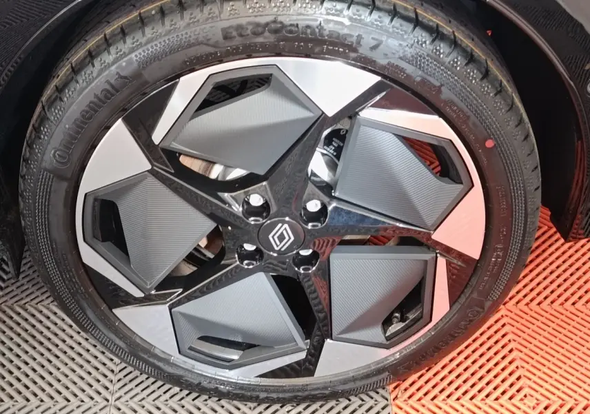 Gros plan sur la jante avant droite de la Renault Clio techno gris foncé, design moderne et géométrique.