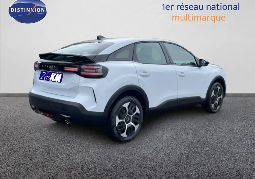 Vue 3/4 arrière droite d'une Citroën C4 blanc métal avec toit noir et feux arrière LED distinctifs.
