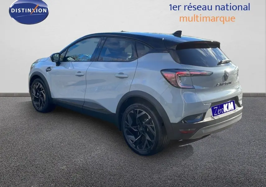 Renault Captur E-Tech hybride gris Rafale toit noir, vue 3/4 arrière côté gauche avec jantes noires distinctives.