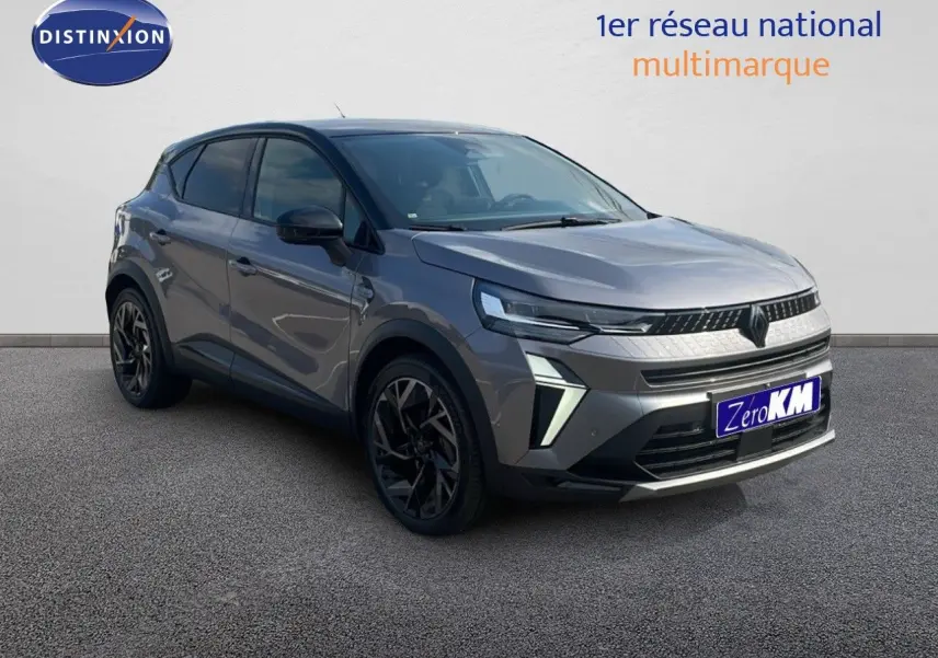 Renault Captur E-Tech hybride gris cassiopée métal avec toit noir, vue 3/4 avant mettant en valeur ses optiques LED et jantes noires.