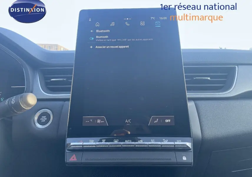 Vue intérieure centrée sur l'écran tactile vertical du tableau de bord du Renault Captur rouge passion 2025, finition E-Tech Hybrid.