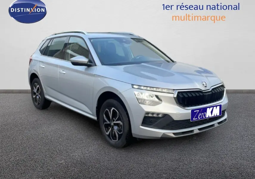 Vue 3/4 avant d'un Skoda Kamiq gris argent métallisé avec jantes bi-ton et calandre noire distinctive.