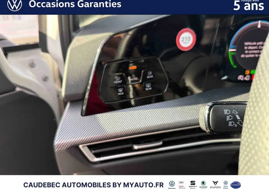 Détail du tableau de bord noir avec commandes climatisation et volant partiel de la Volkswagen Golf blanche 2026.