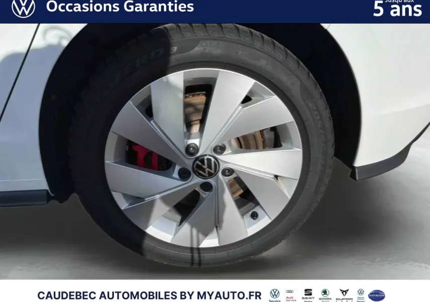 Gros plan sur la roue avant droite blanche d'une Volkswagen Golf 1.5 eHybrid 2025 avec jante alliage 17'' et étrier de frein rouge.