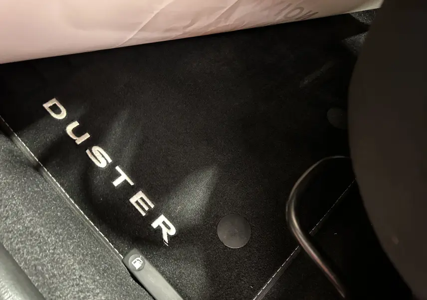 Tapis de sol noir avec inscription DUSTER en blanc, vue rapprochée de l'intérieur du Dacia Duster 2022.