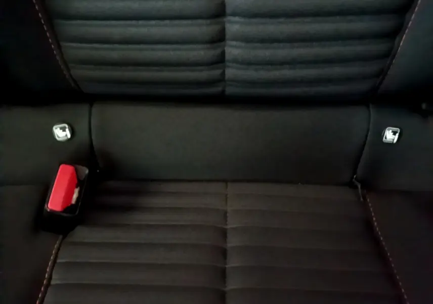 Gros plan sur la banquette arrière noire de la Peugeot 208 Electrique Active Business avec ceintures de sécurité visibles.