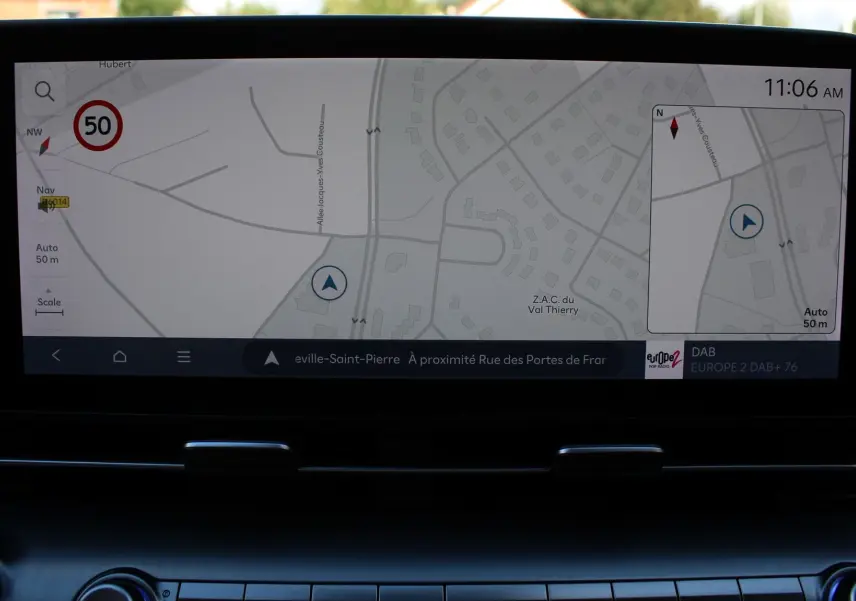 Vue intérieure du tableau de bord du Hyundai Kona 2024, écran tactile affichant la navigation GPS en mode carte.
