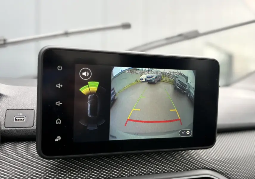 Écran tactile intérieur montrant la caméra de recul avec guidage coloré dans un Dacia Jogger Kaki Lichen.